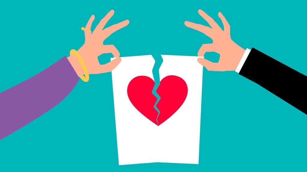 In this image, we see the arms of two partners, each holding the edge of a drawing of a heart. The image is ripping in the middle, creating a split through the heart.