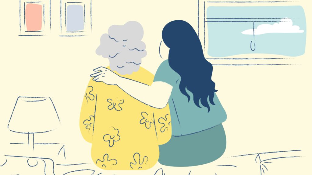 A young woman and an older woman sit on a bed, with their backs facing us. The young woman has an arm around the older woman, in a gesture of comfort.